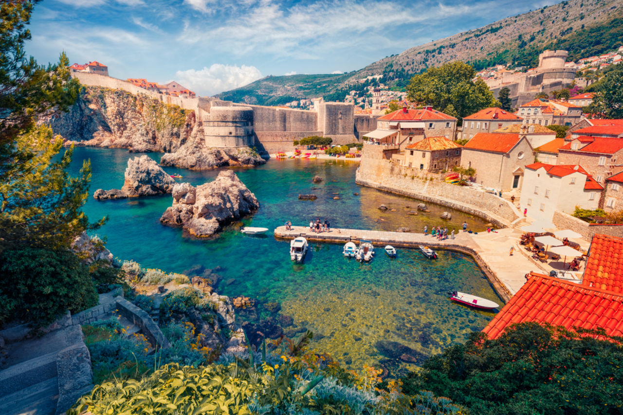 bridge over blue water surrounded by a town